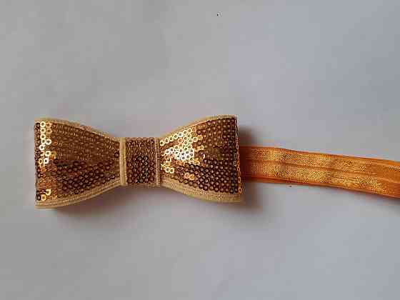 Пов'язка дитяча світло-оранжева з паєтками - бант близько 10см, окружність 36-48см Київ