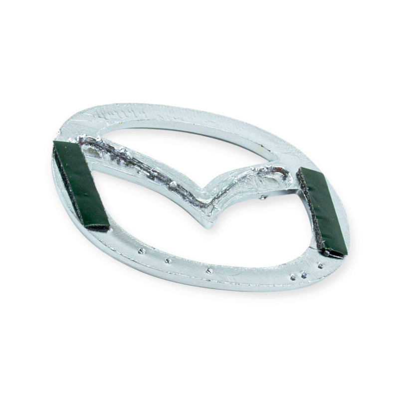 Емблема решітки mazda 626-323 1992-> нова 63x50мм Мукачево - фото 1